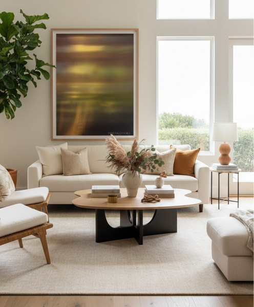 Modern living room with neutral tones, a sofa, coffee table, and decorative elements. Abstract photography print on the wall green ethereal and beautiful